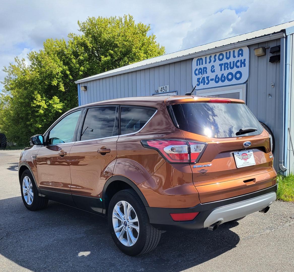 2017 Copper /Black Ford Escape SE (1FMCU9GD1HU) with an 1.5L I4 engine, 6 Speed Auto transmission, located at 450 N Russell, Missoula, MT, 59801, (406) 543-6600, 46.874496, -114.017433 - Nice Low Mile All Wheel Drive. Only 59K Miles. 1.5L I4 Engine. 6 Speed Automatic Transmission. Very Clean. Power drivers Seat. Air. Cruise. Tilt. Power Windows and Locks. Backup Camera. - Photo#1